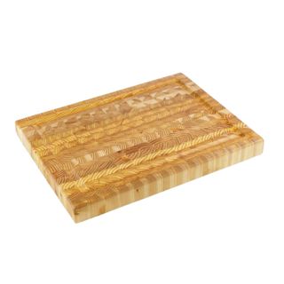 A light brown wooden cutting board with a wave pattern