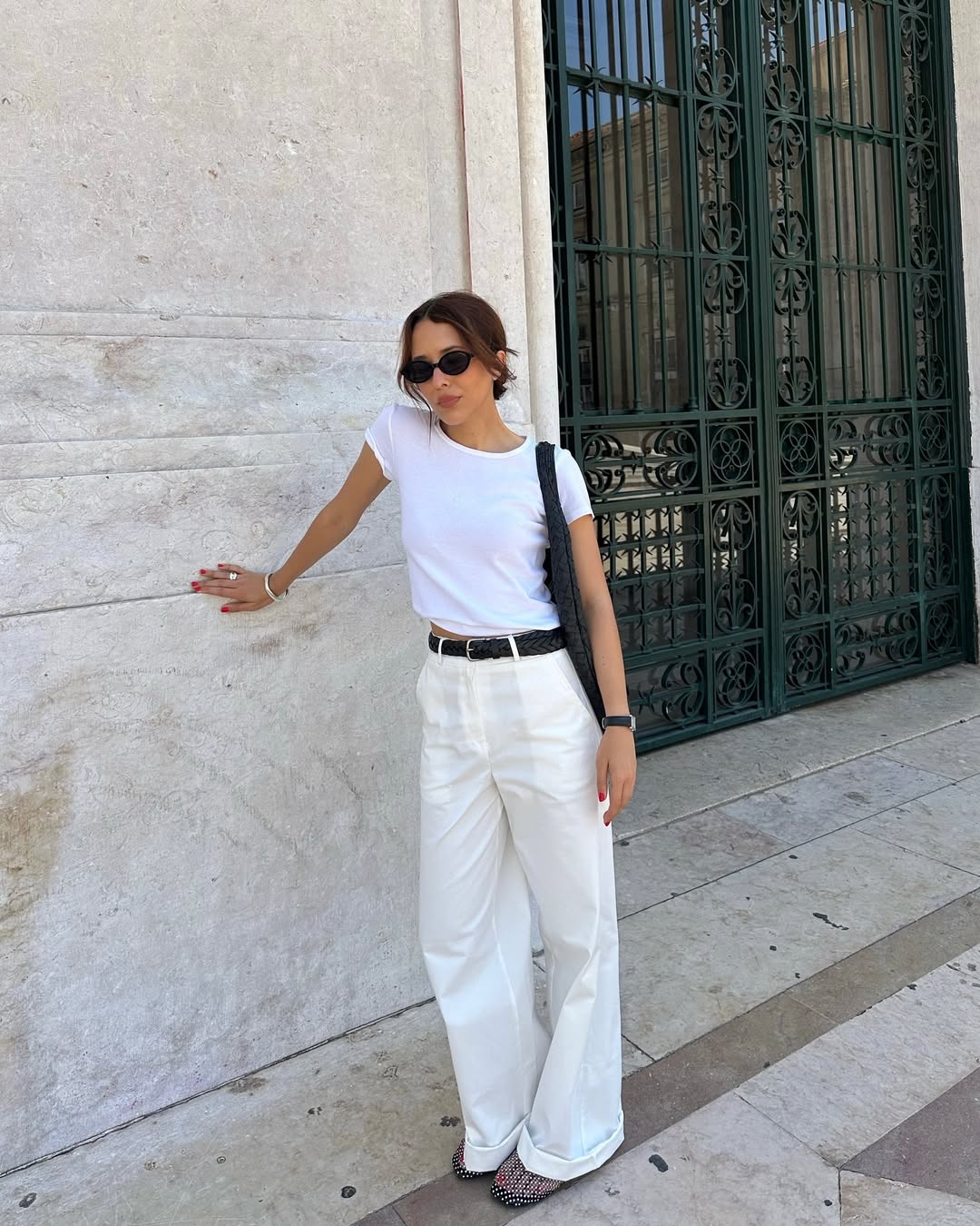Debora in all white outfit and black mesh flats
