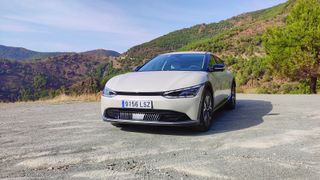 Front on, at an angle, view of Kia EV6 parked in a layby in the mountains