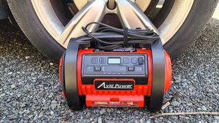 Avid Power Tire Inflator next to car tire