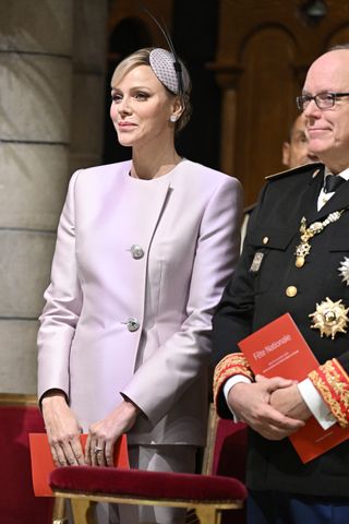 Princess Charlene wears a lilac pant suit and her engagement ring from Prince Albert for Monaco Day