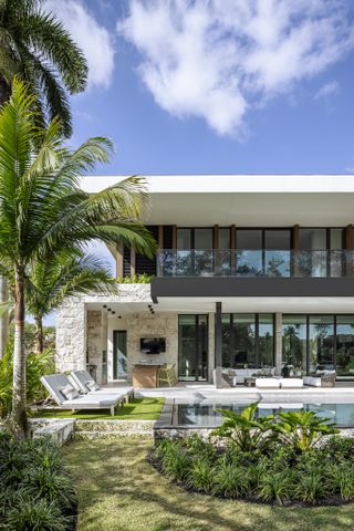 Exterior facing the garden and swimming pool at the Tarpon Bend Residence