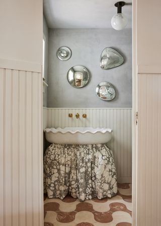 A bathroom with grey walls warmed up with neutrals