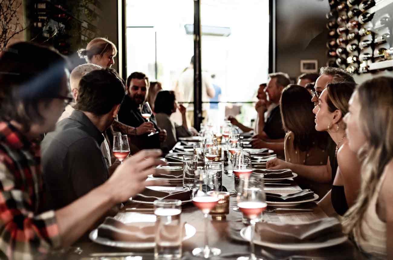 People dining at a table in Los Angeles wine bar Wife and the Somm