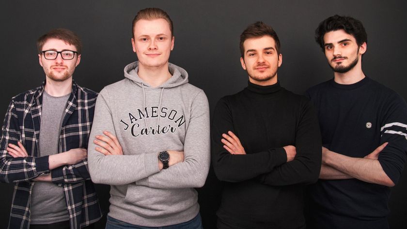 Four young men standing in a line against a dark background, all with their arms crossed, looking at the camera.