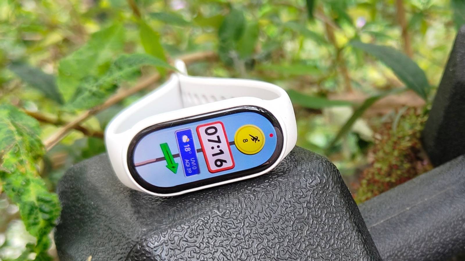 The Xiaomi Smart Band 10 atop a dumbell.