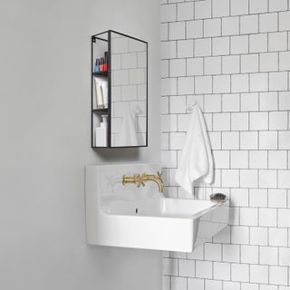 White bathroom decor with wall hung sink and industrial mirrored bathroom cabinet