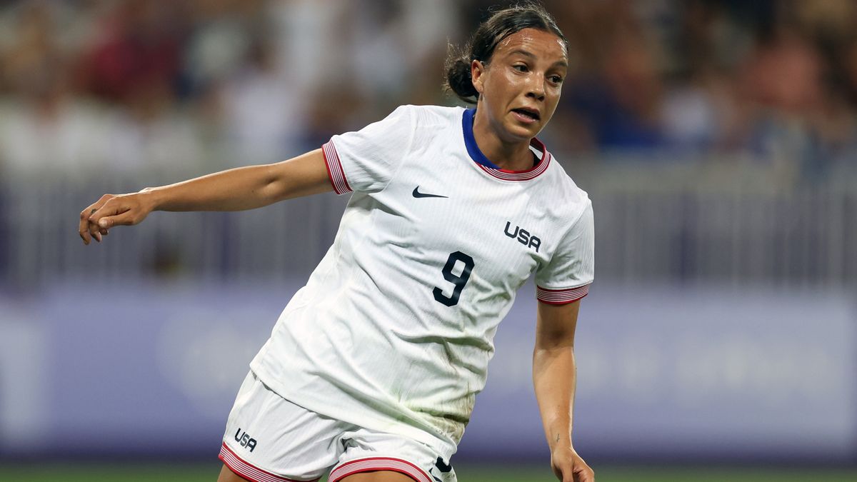 Mallory Swanson, in the white Team USA kit, celebrates a goal in the women&#039;s soccer at 2024 Olympic Games.