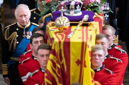 King Charles III with Queen Elizabeth II's coffin