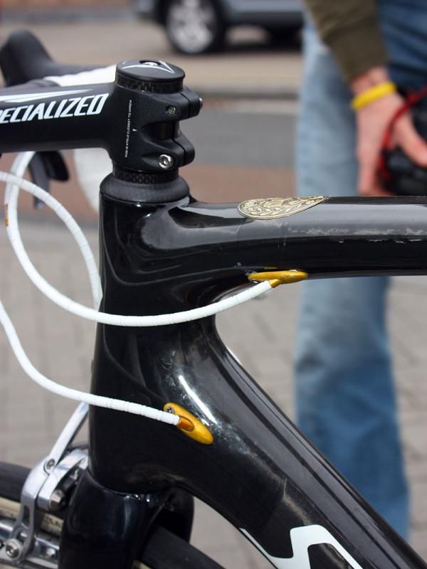 Fabian Cancellara's (Saxo Bank) Specialized 'Project Black' prototype features internal cable routing - and gold anodized bits.