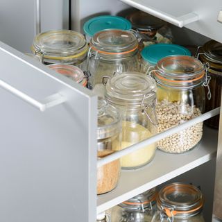Open drawer showing food stored in clear glass jars