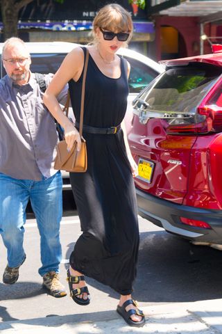 Taylor Swift spotted in New York wearing a long back dress with belt and sandals