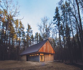 A wooden structure in the middle of a wooded area