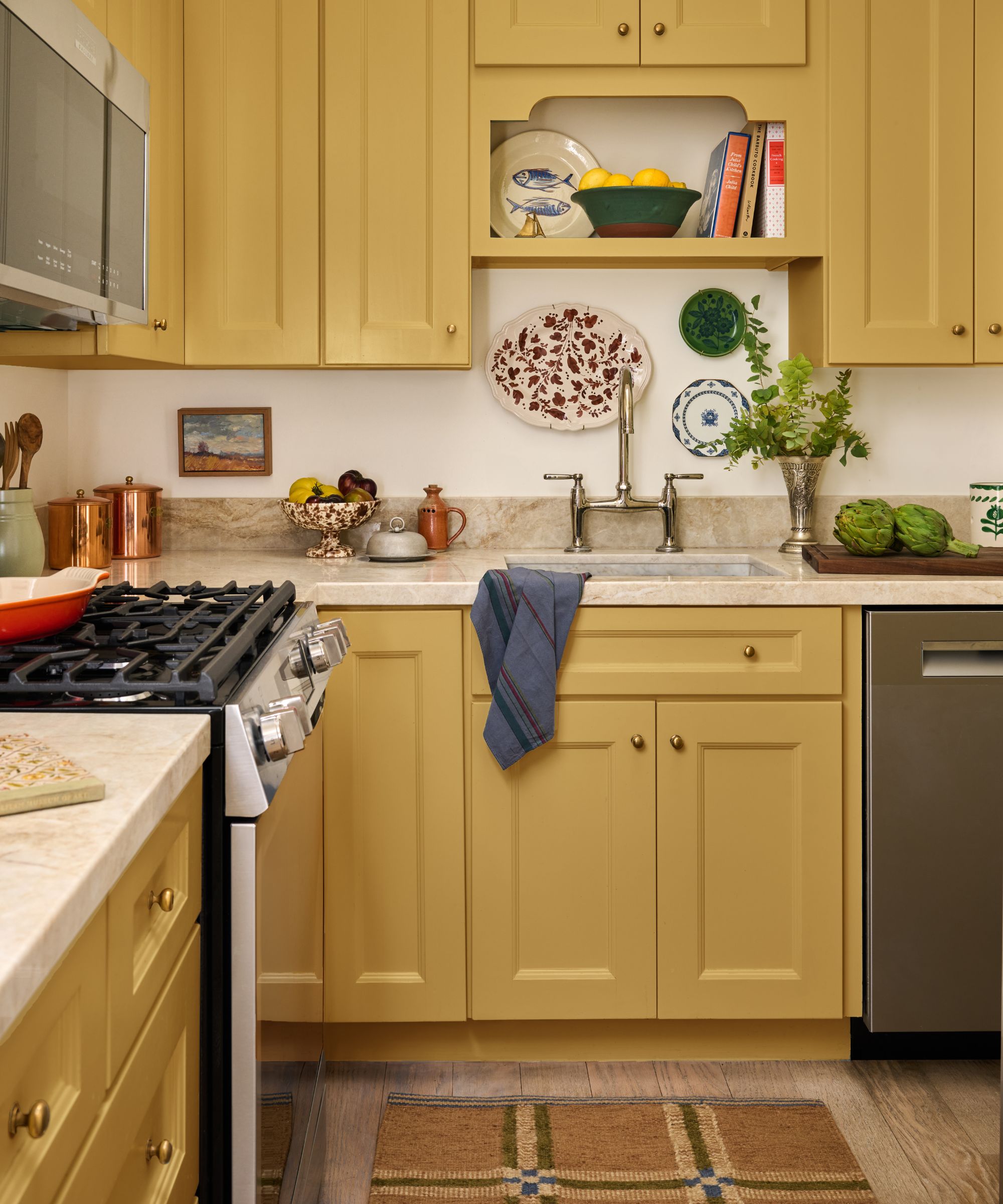 a sunshine yellow small kitchen with stone counters, open shelf detail and vintage decor
