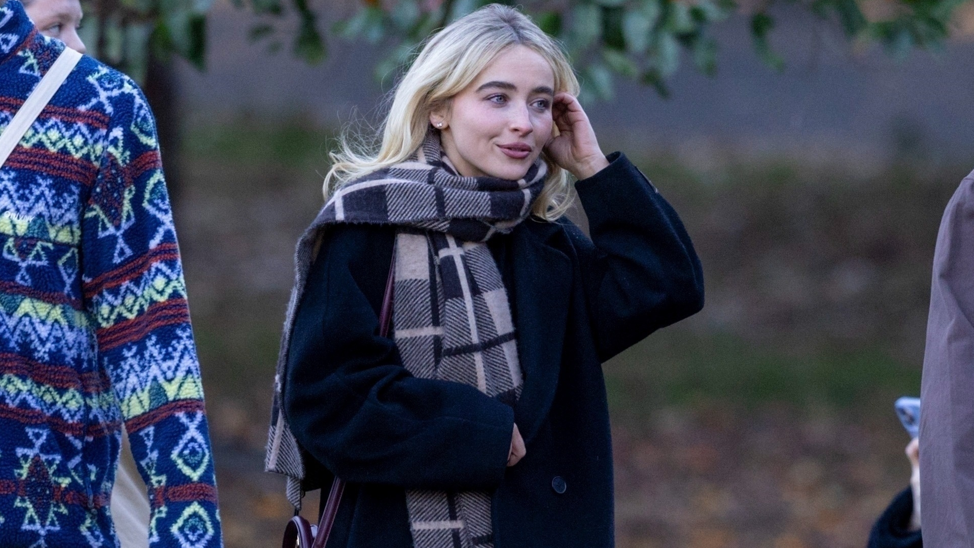 Sabrina Carpenter was spotted in New York's Brooklyn wearing a black coat, a plaid scarf, and a burgundy Celine bag