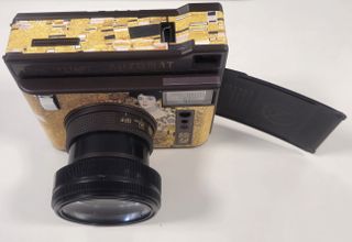 Front view with wide angle adapter and an ejected first slide