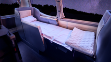 Reclining bed inside Twiliner sleeper bus