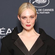 Elle Fanning wears a black Givenchy skirt suit on the red carpet for the L'Oreal Lights on Women's Worth Award at the 78th Cannes film festival on May 23, 2025 