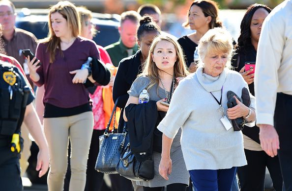 Survivors leave the office building in San Bernardino.