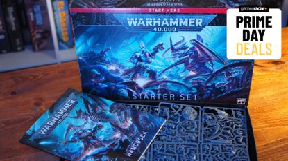 The Warhammer 40,000 Starter Set box and contents on a wooden table, with a 'Prime Day Deals' badge in the top corner