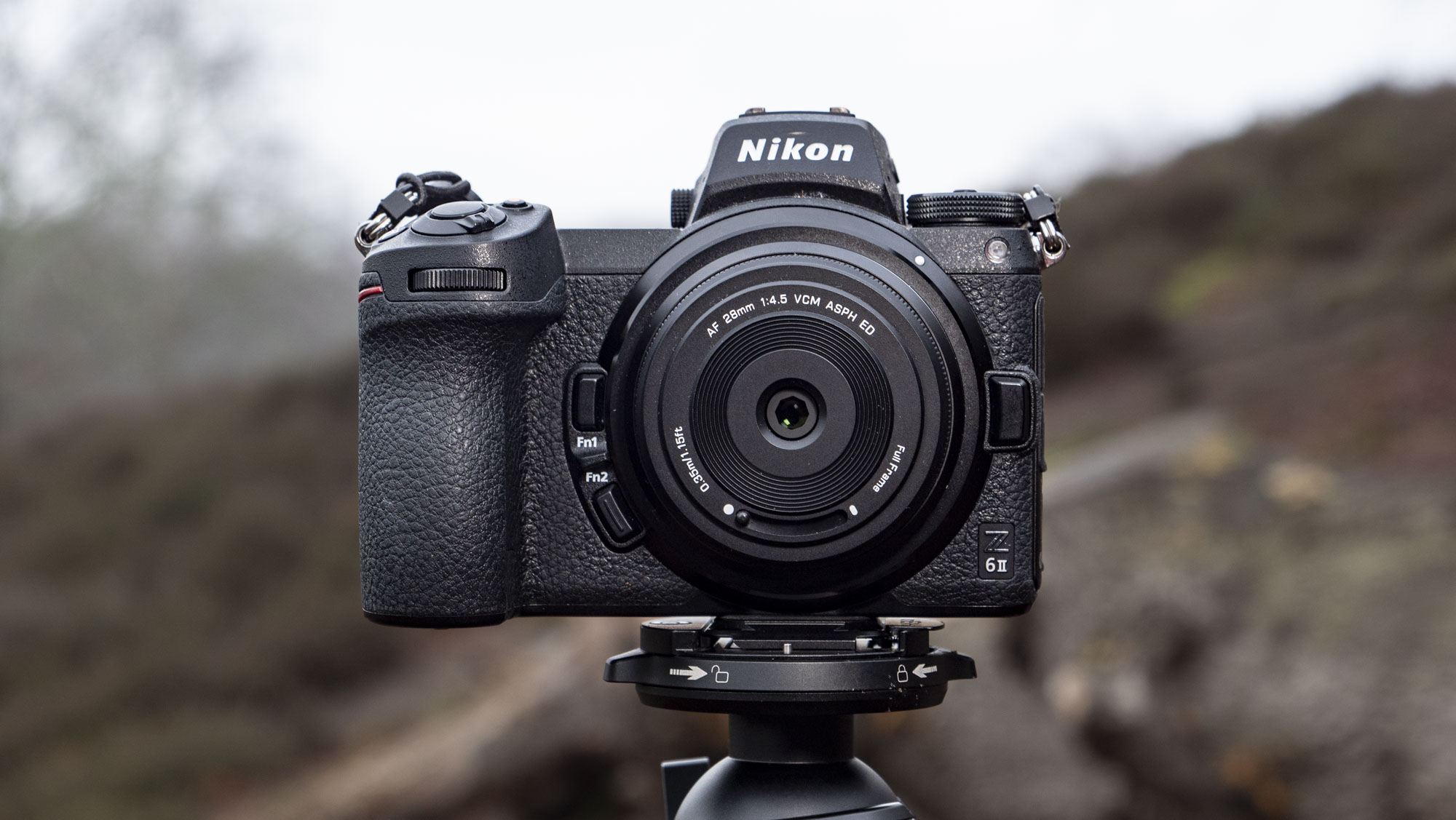 Viltrox AF 28mm f/4.5 body cap lens mounted to a Nikon mirrorless camera, outdoors in open nature