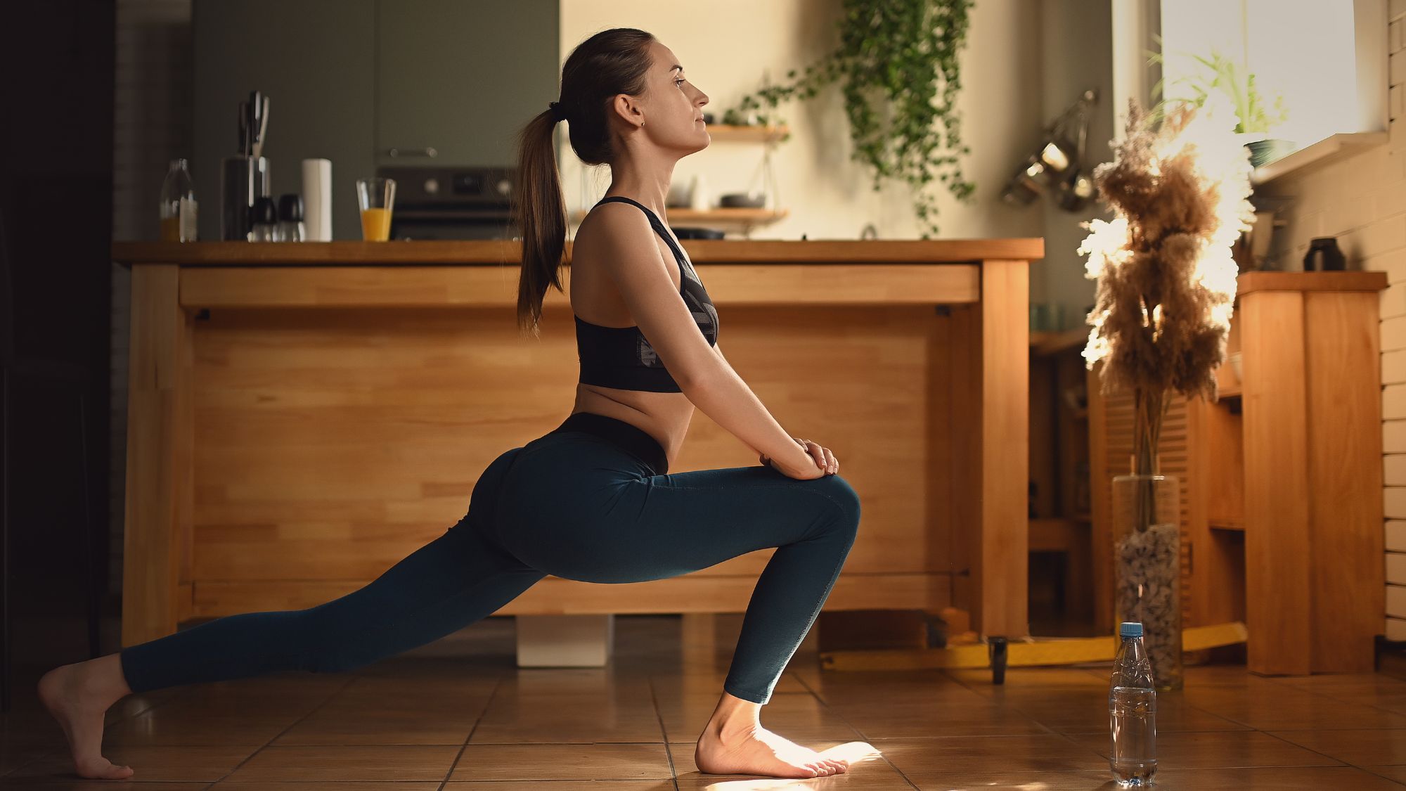 Indoor workouts: A woman stretching indoors