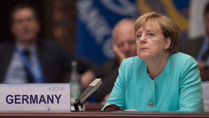 HANGZHOU, CHINA - SEPTEMBER 4: German Chancellor Angela Merkel listens to Chinese President Xi Jinping speech during the opening ceremony of the G20 Leaders Summit on September 4, 2016 in Han