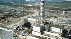 The damaged Chernobyl nuclear power plant: a group of ruined and damaged gray, green and white buildings