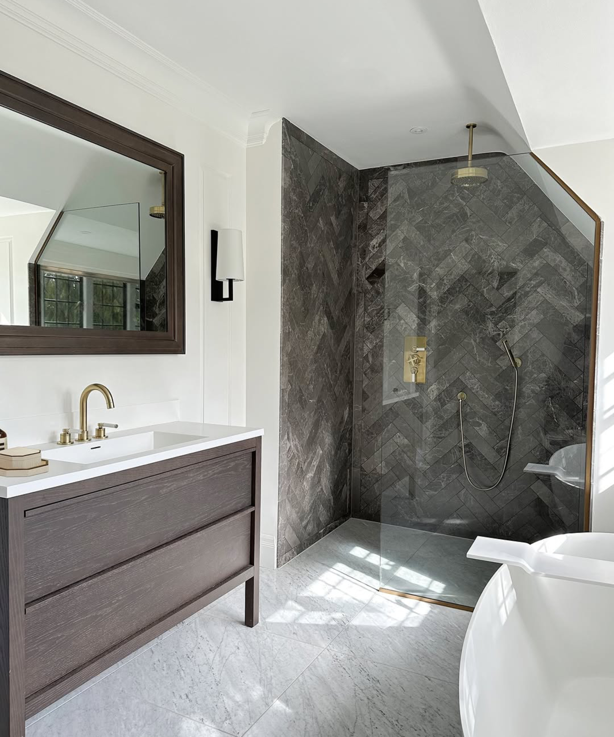 grey bathroom with dark grey herringbone tiled walk in shower