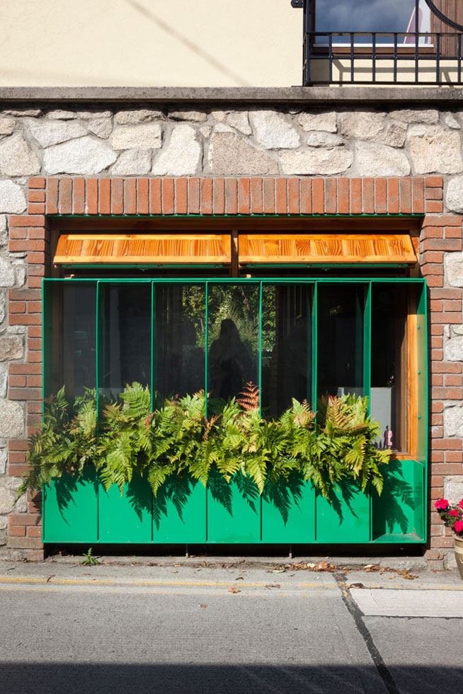 a garage conversion with a new green window