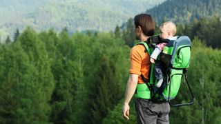 Father with 1 year old son in baby carrier