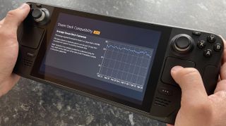 Hands hold a Steam Deck displaying a screen with a "Steam Deck Compatibility" chart. The graph shows a steady line, indicating performance metrics.