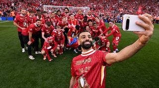 Mohamed Salah takes a selfie as Liverpool celebrate their Premier League title after a 5-1 win over Tottenham at Anfield in April 2025.