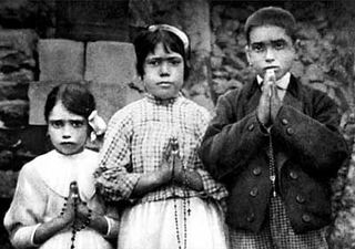 The three Fátima children: Lucia Santos, 10, in the middle; with her cousins, Jacinta, 7, and Francisco Marto, 9.