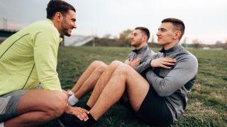 Men perform sit-ups