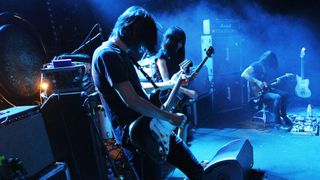 The members of the Japanese experimental rock band Mono perform on stage at the Trabendo in Paris on December 11, 2014