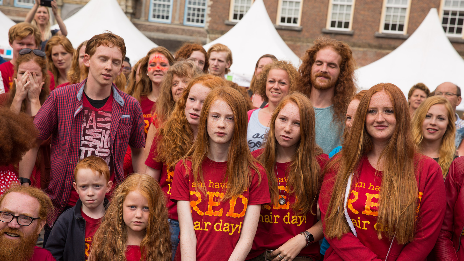 A group of people with red hair pose for a picture.