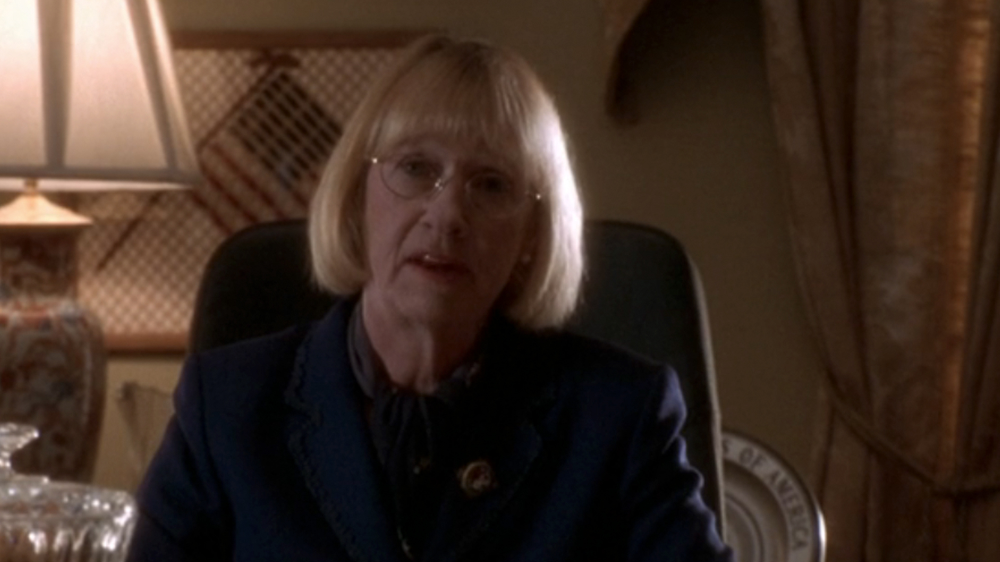 Katheryn Joosten sitting at her desk in The West Wing