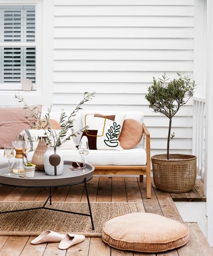 outdoor living with white wall and sofa