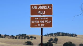 A sign posted at the San Andreas Fault, separating the Pacific and the North American tectonic plates near Parkfield, California on July 12, 2019 in a remote part of California.