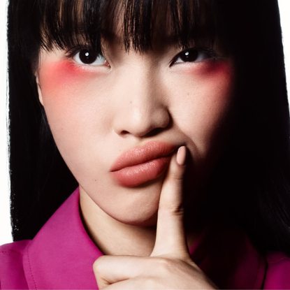 A woman wearing Make Up For Ever Artist Crayon on lips, cheeks and eyes. 