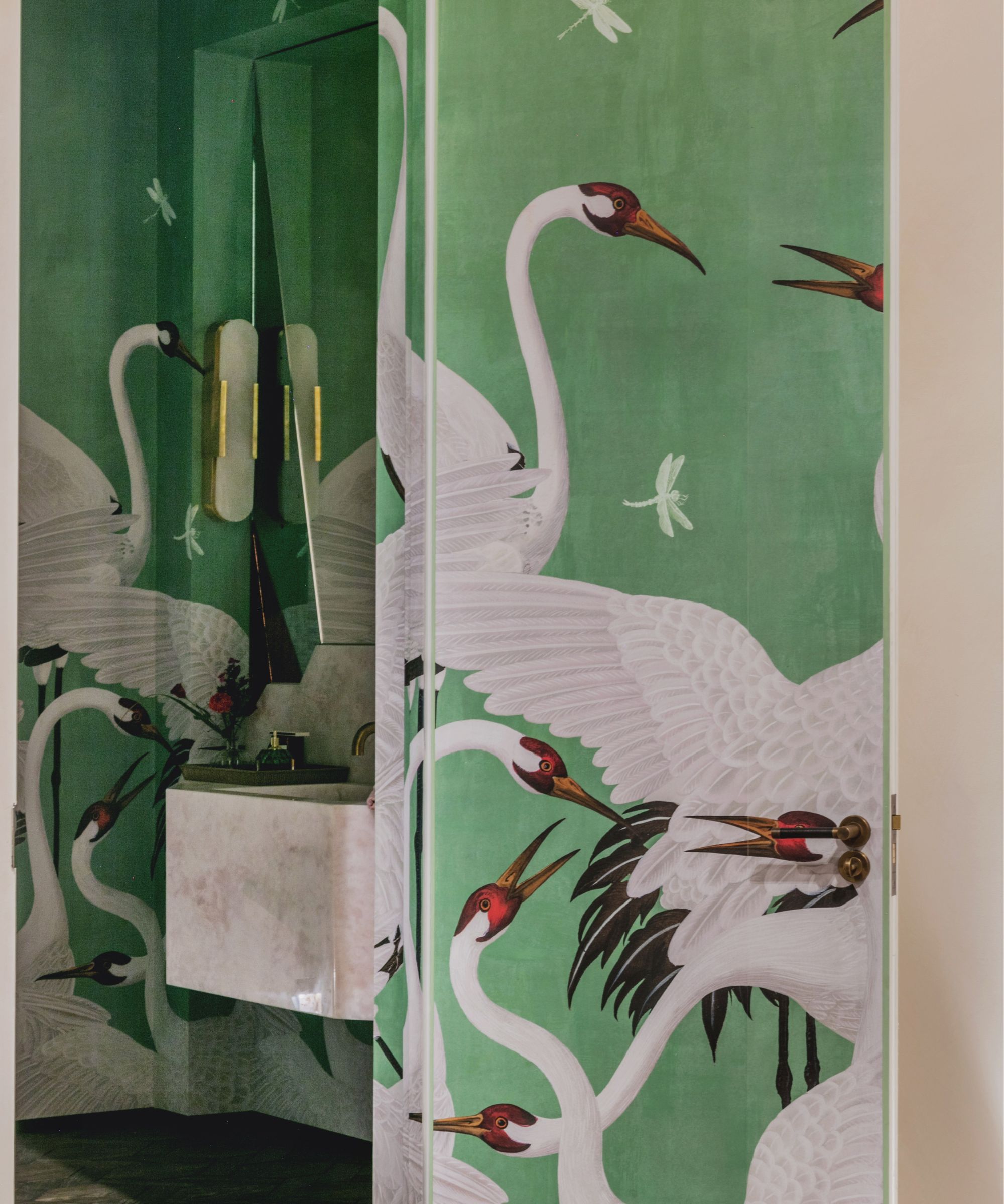 green stork wallpaper in a small ensuite bathroom by studio duggan