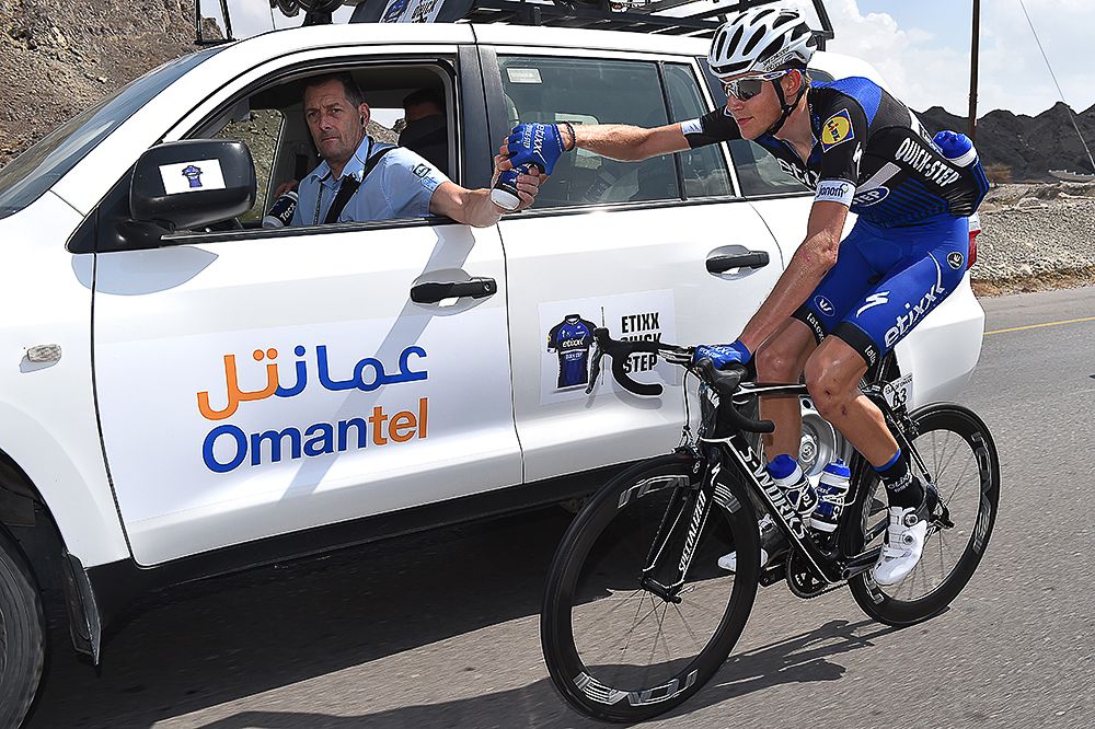 Laurens De Plus gets a bottle from the team car