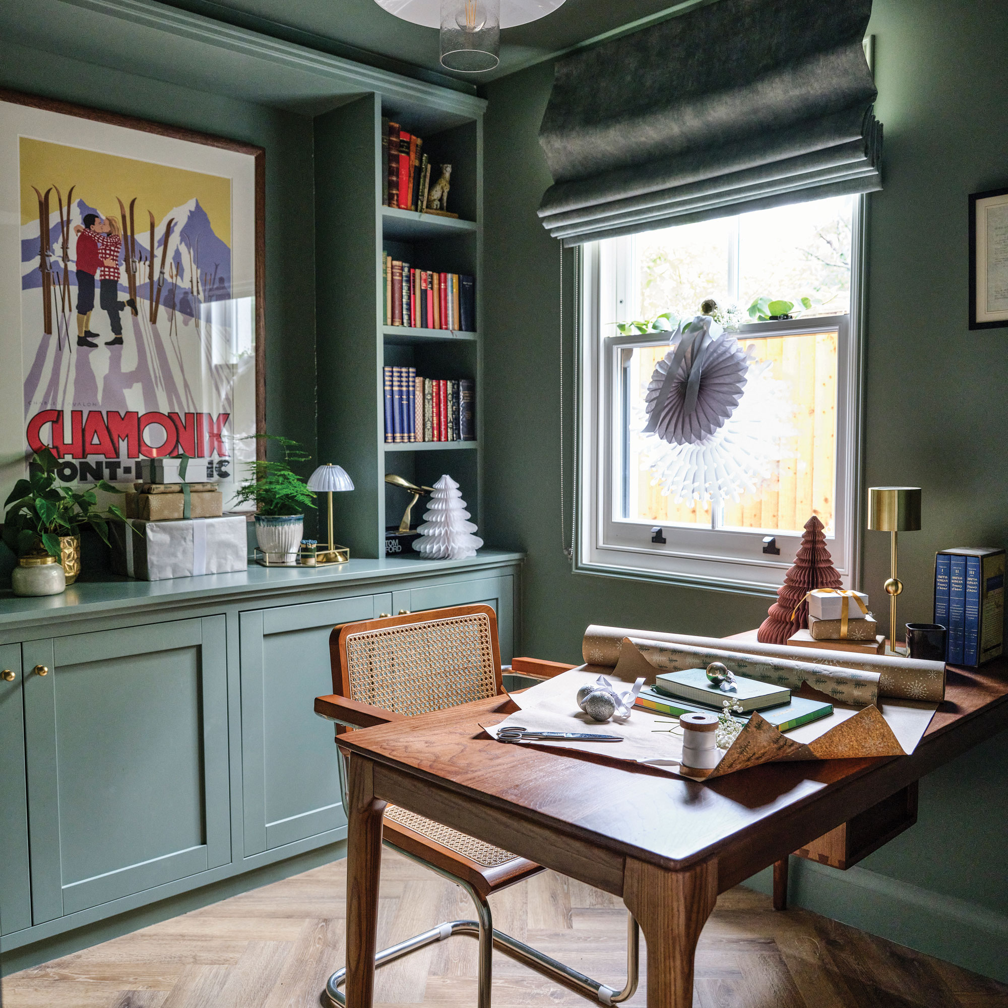Green study with wooden desk, and mid century chair