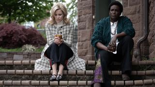 Elizabeth Banks as Joy and Wunmi Mosaku as Gwen sitting on the steps in Call Jane