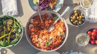 Bowl of pasta with tomato sauce and other Mediterranean dishes