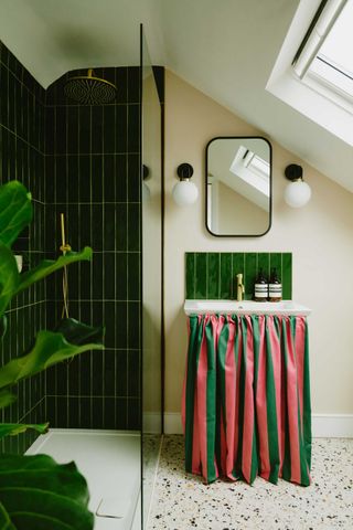 a modern bathroom with a striped sink skirt