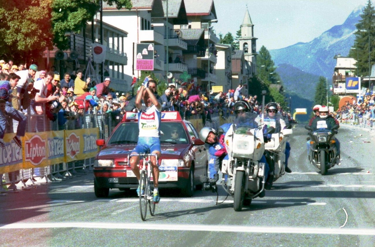 Pantani raises his arms as he crosses the line