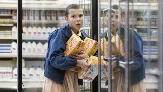 Eleven stealing Eggos from a grocery store in Stranger Things Season 1