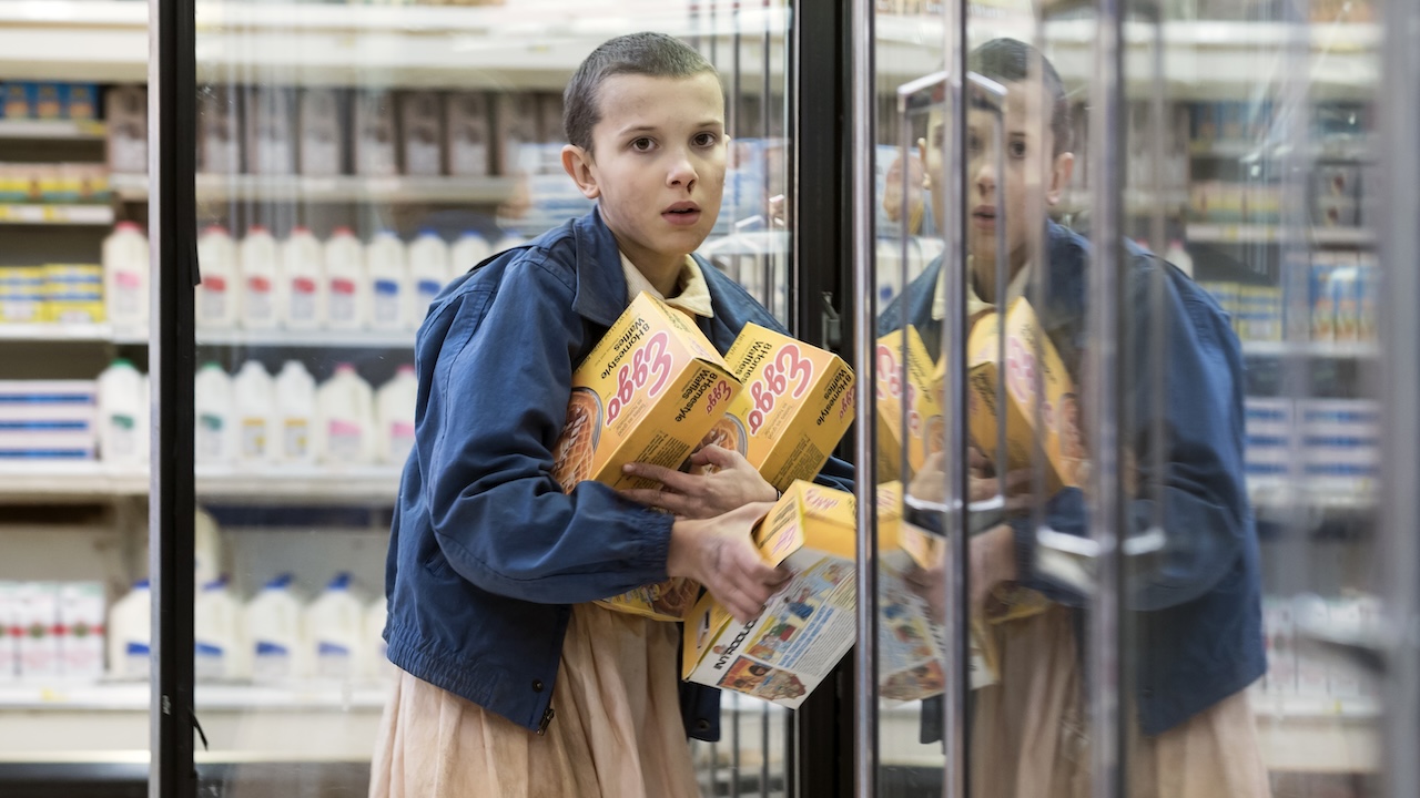 Eleven stealing Eggos from a grocery store in Stranger Things Season 1